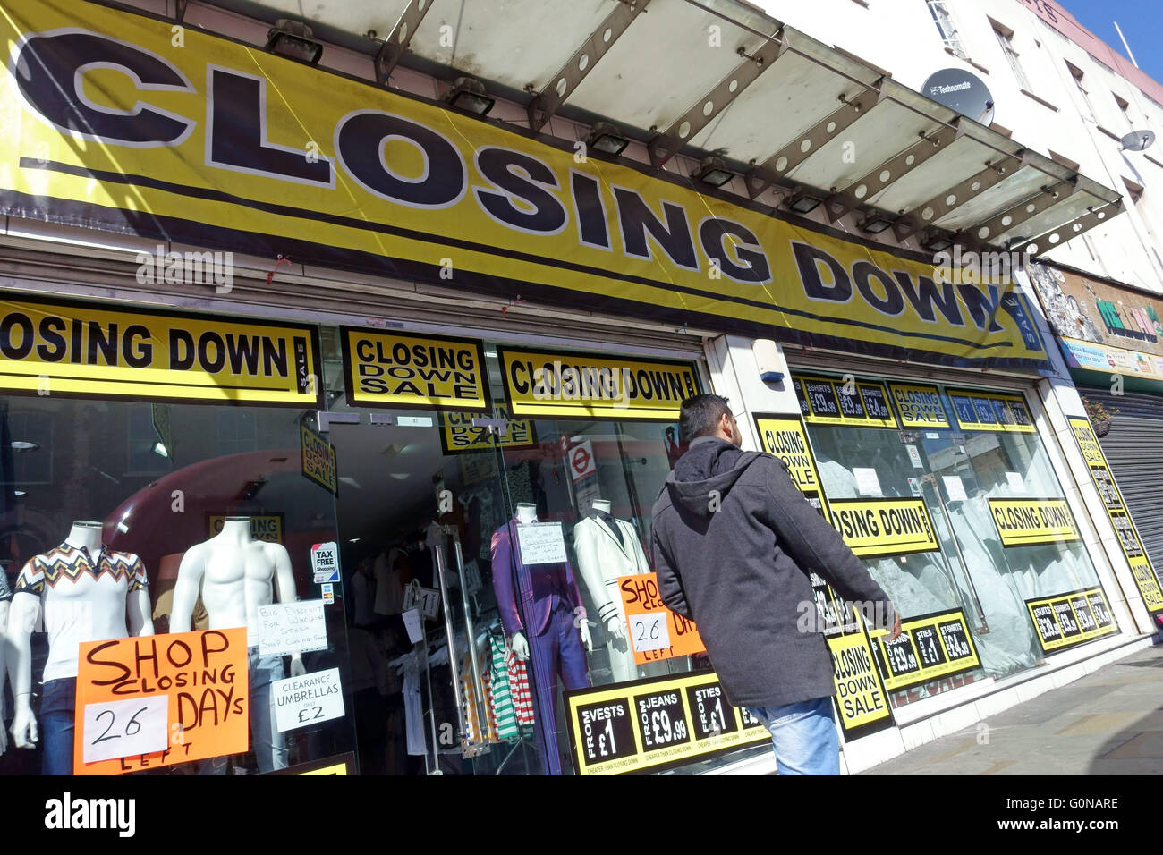 Gentrification in Dalston, East London - old fashioned mens clothing shop closing down in Kingsland High Street Stock Photo