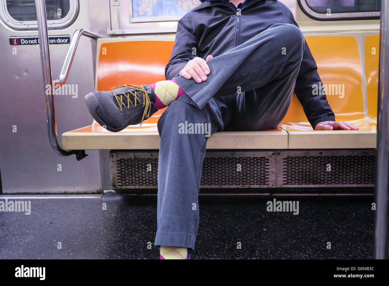 Man Hogging More than One Seat (man spreading) on New York City Subway (tube), NYC, USA Stock Photo
