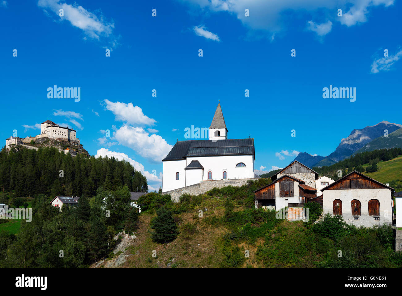 Europe, Switzerland, Graubunden, Engadine, Scuol Tarasp, Scuol castle, (Schloss Tarasp), village church Stock Photo