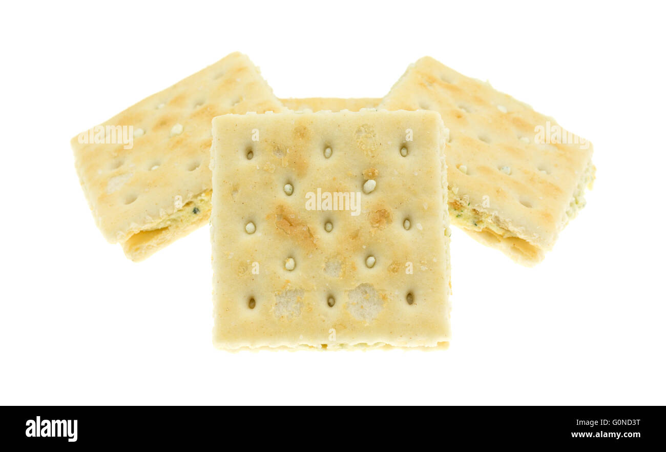 Several cream cheese and chives crackers isolated on a white background. Stock Photo