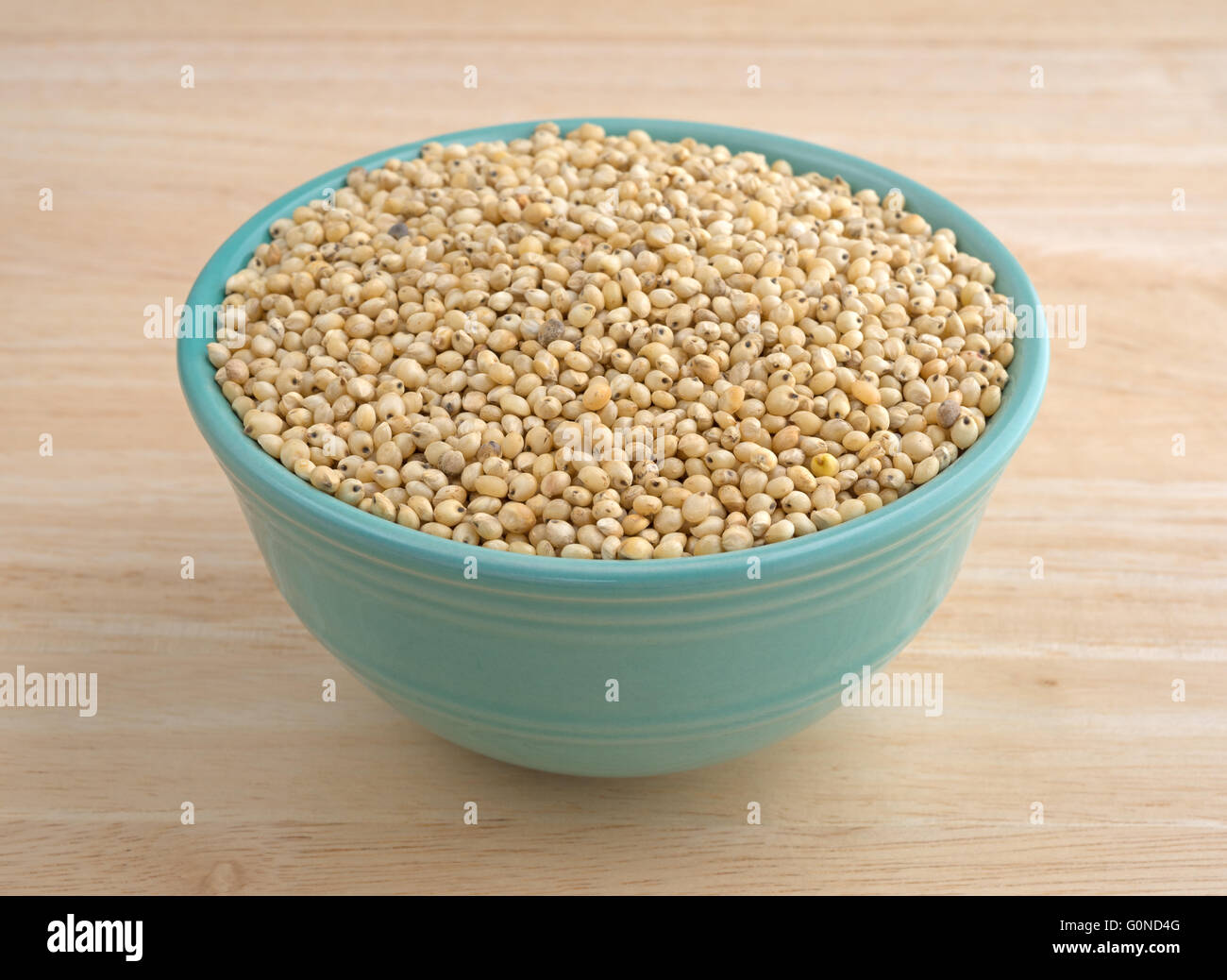 A small bowl filled with whole grain organic seeds on a wood