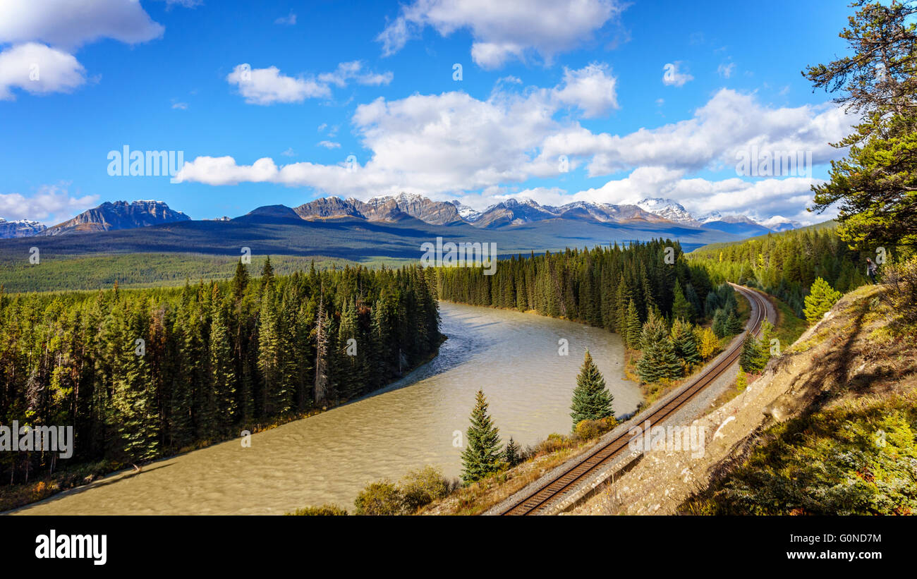 The railroad following Morant's Curve in the Bow River with Haddo Peak, Saddle Mountain and Fairview Mountain in the background. Stock Photo
