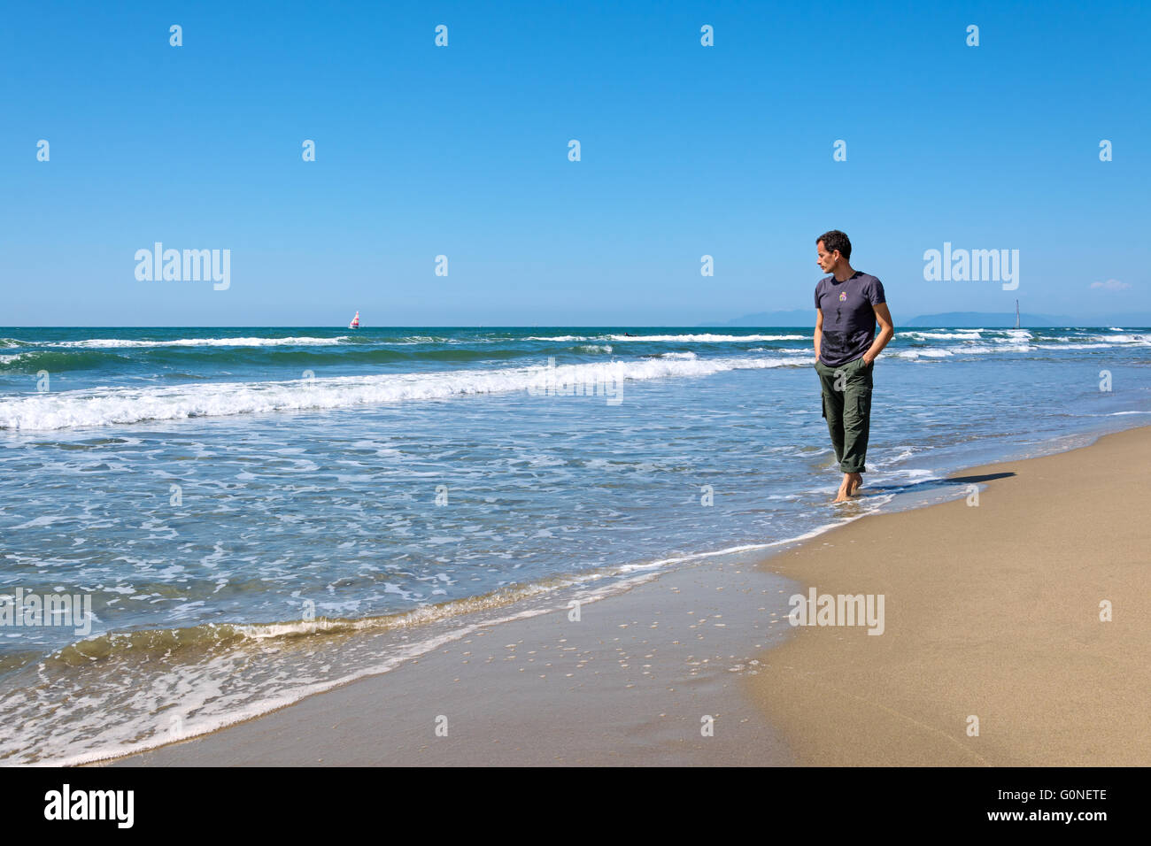 man walking on the beach Stock Photo - Alamy