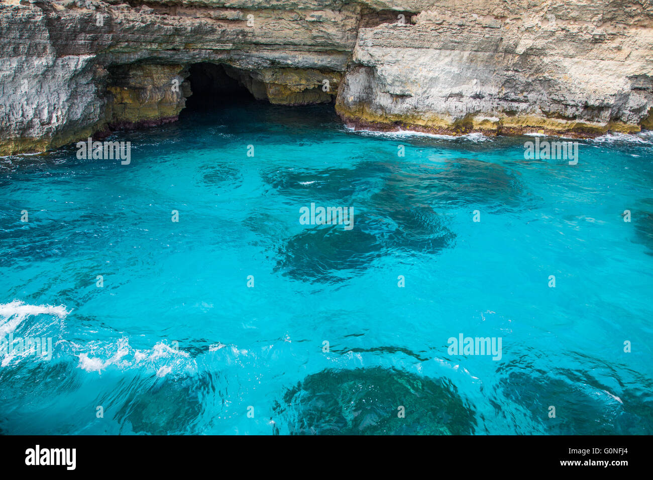 Astonishing light blue sea water in mediterranean sea with a cave Stock Photo