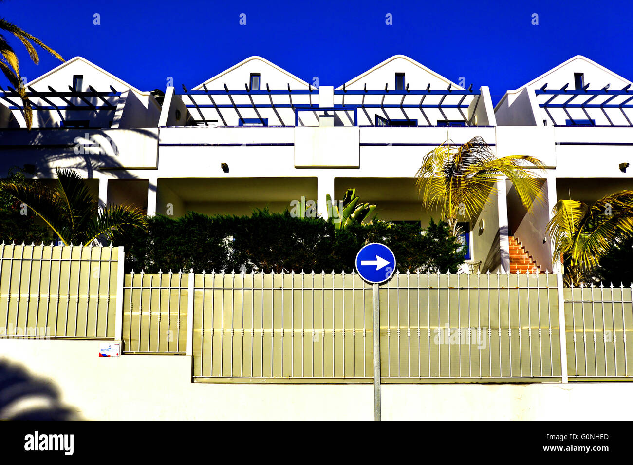 Lanzarote Puerto del Carmen white wall apartments blue sky and arrow