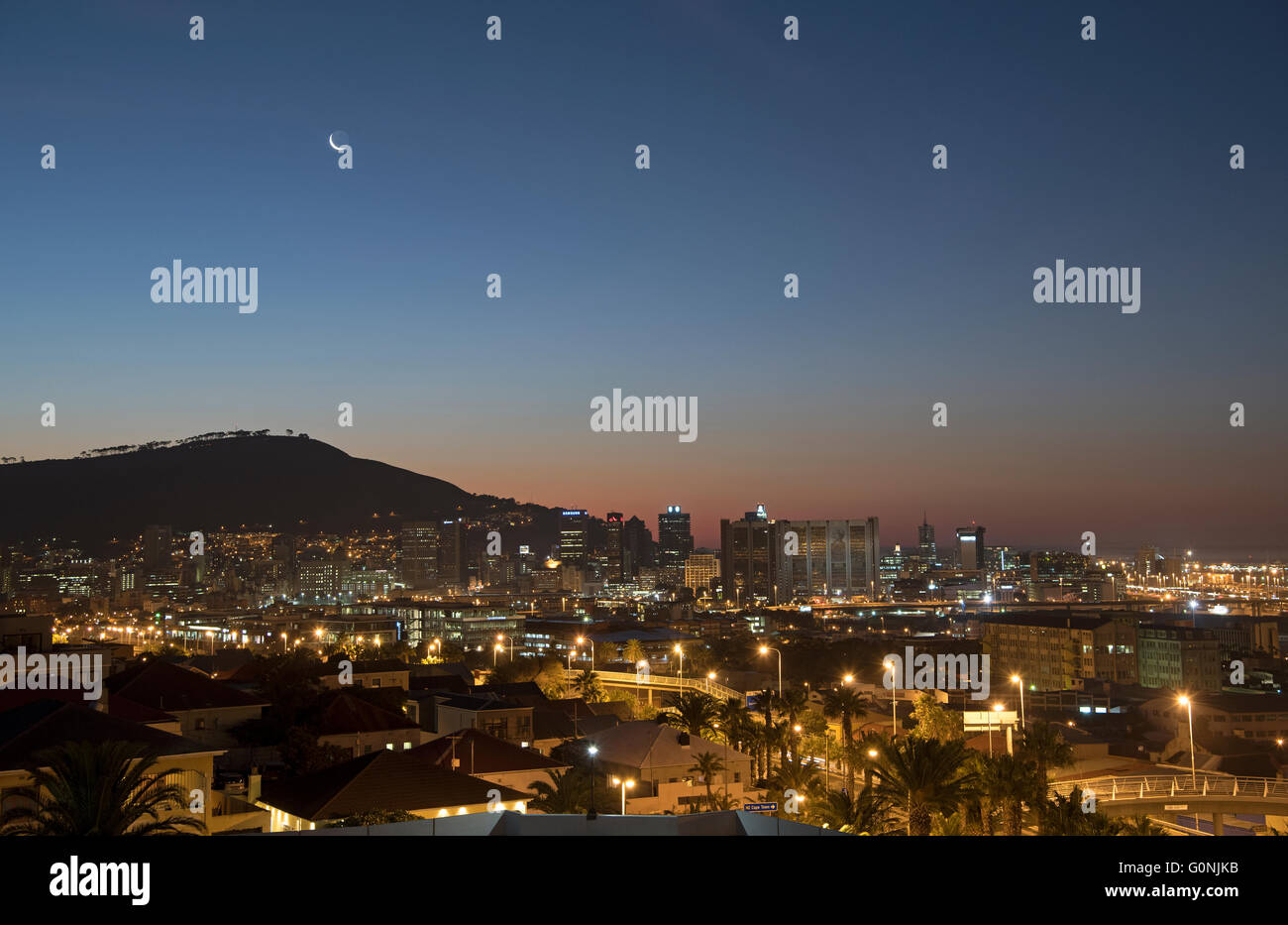 A new moon over Signal Hill in Cape Town and the glow of the Mother