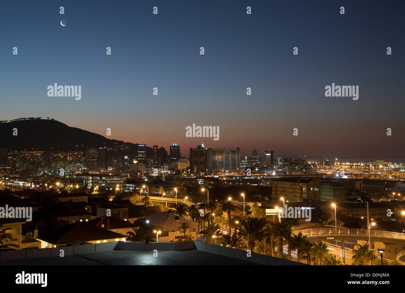 A new moon over Signal Hill in Cape Town and the glow of the Mother