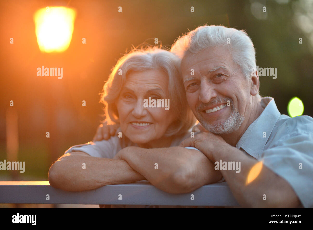 senior couple sitting on bench Stock Photo - Alamy