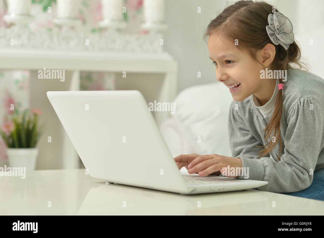 smiling little girl with laptop computer Stock Photo - Alamy