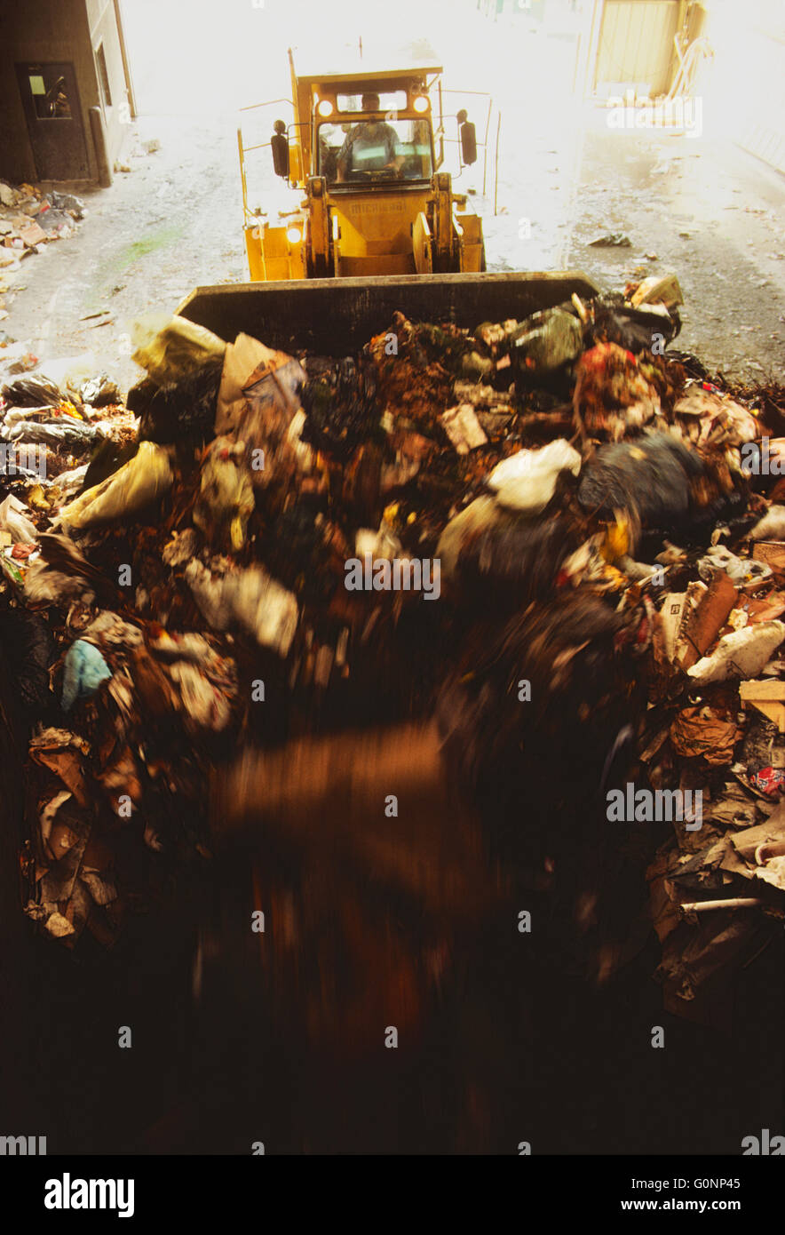 HEAVY EQUIPMENT SORTS TRASH AT A TRANSFER STATION AT CLARKSTOWN, NEW YORK, RECYCLING CENTER & LANDFILL Stock Photo