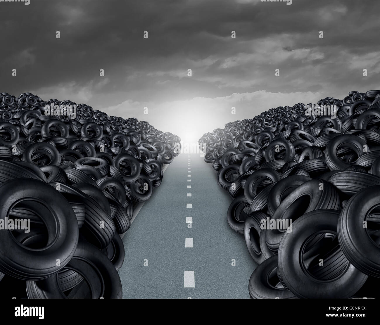 Tire or tyre landfill automotive transportation concept as a heap of black rubber wheels stacked high with a clear road path as Stock Photo