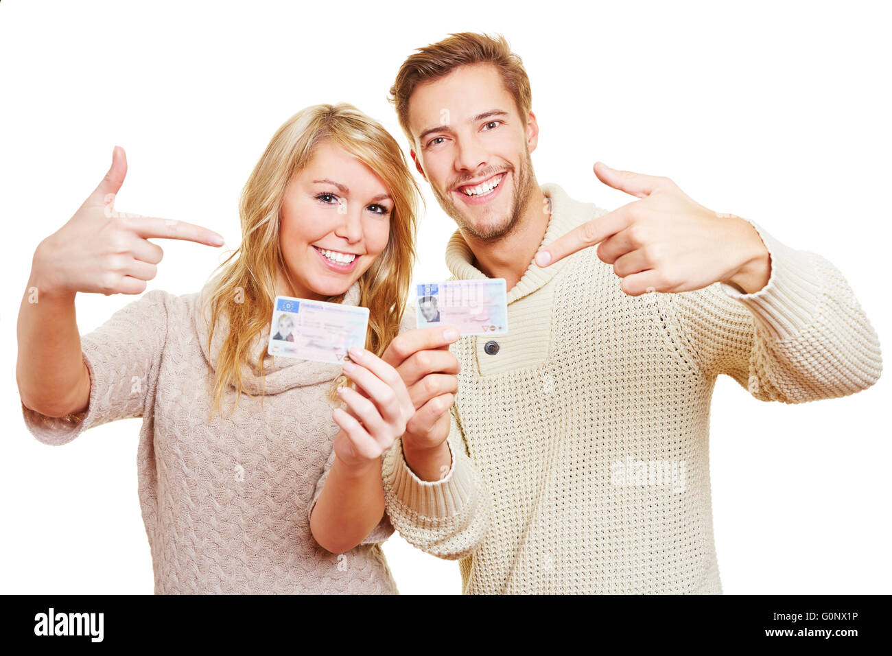 Two happy teenager showing proudly their German drivers licence Stock Photo