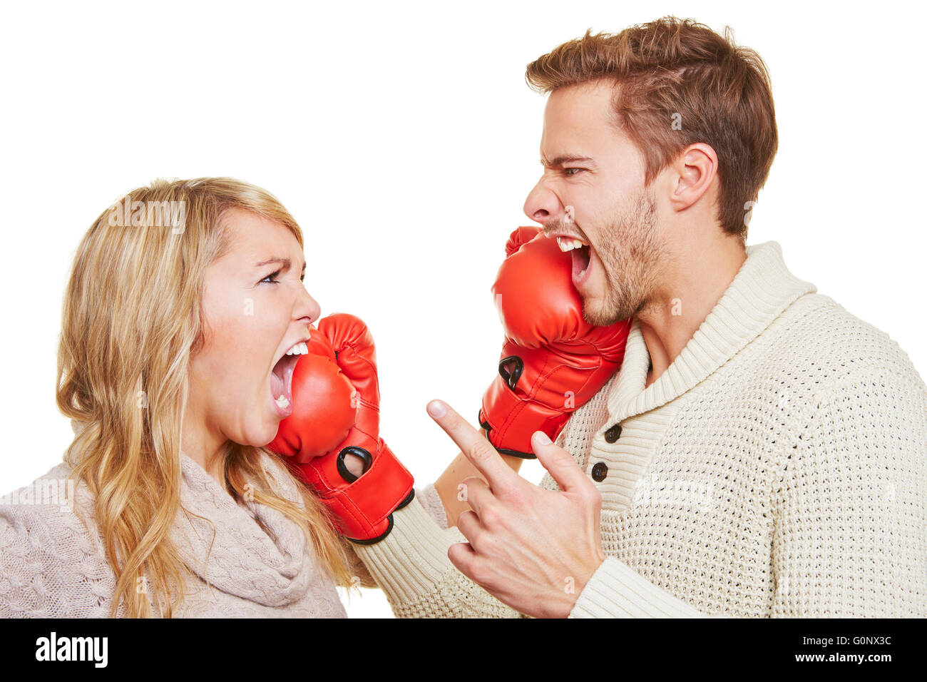 Screaming angry couple fighting with red boxing gloves Stock Photo