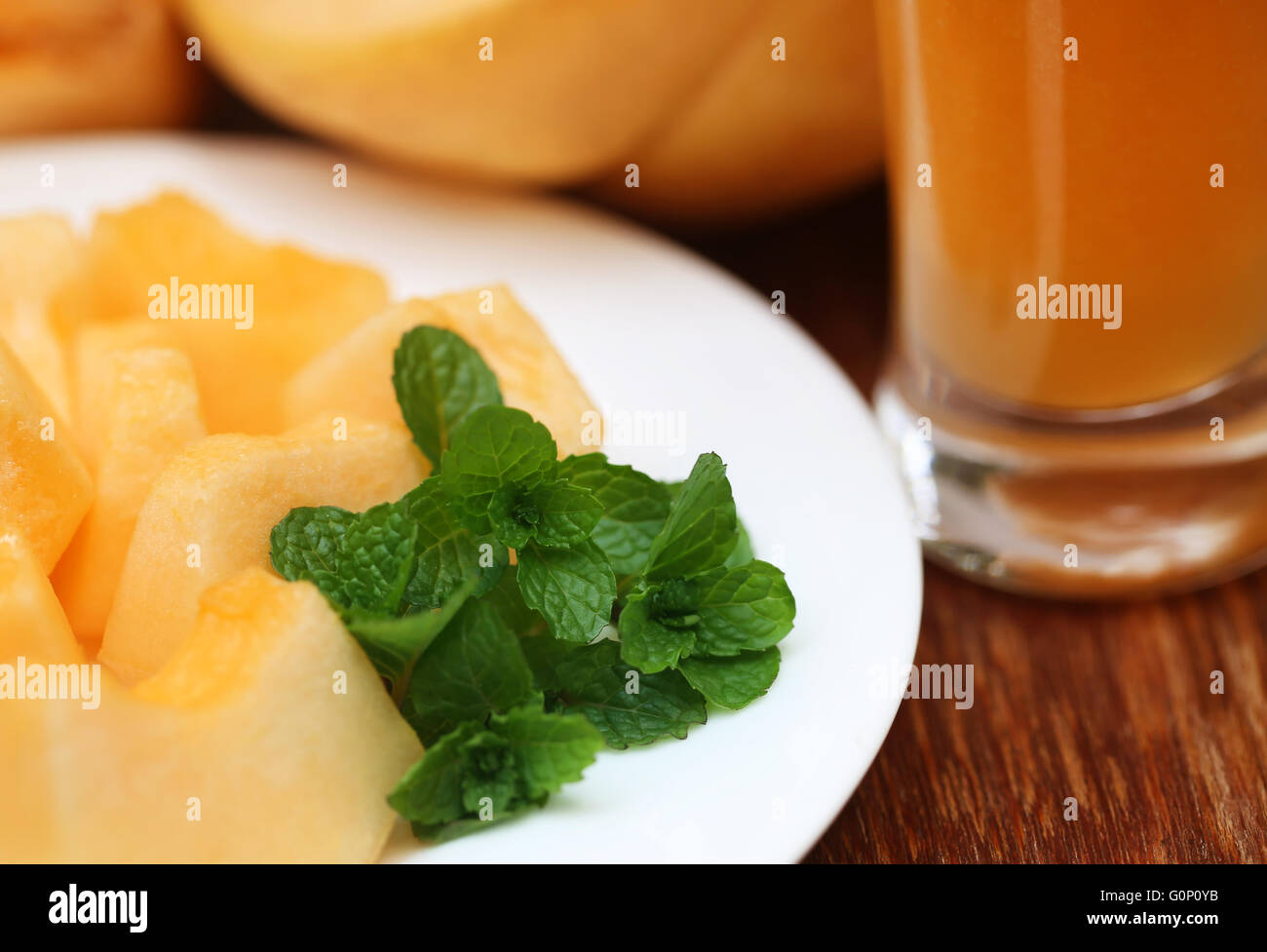 Juice of cucumis melo or muskmelon with green mint leaves Stock Photo