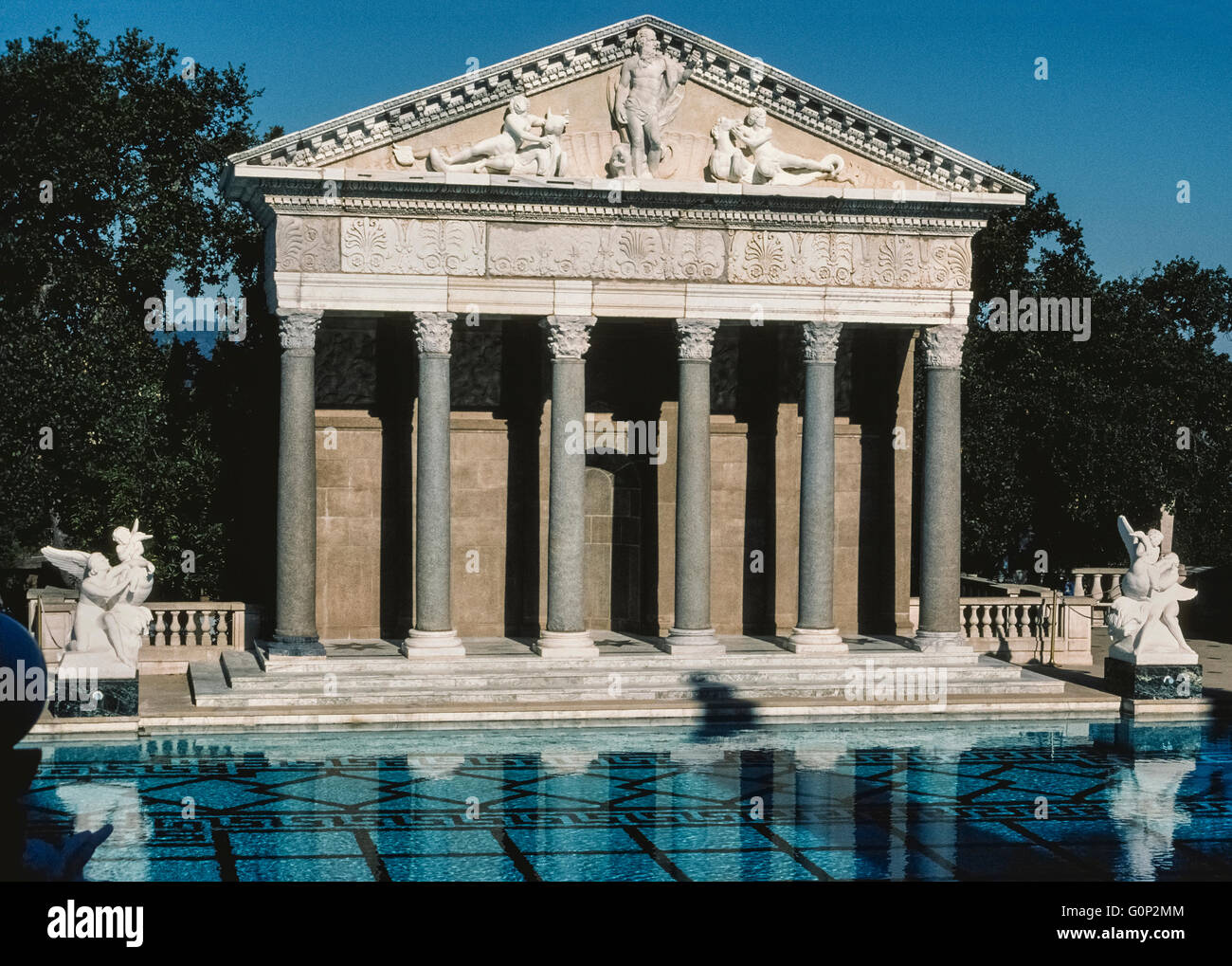 The facade of an ancient Roman temple is the centerpiece of a vast outdoor swimming pool at Hearst Castle, the regal and remote home of fabled American newspaper publisher William Randolph Hearst at San Simeon on the Central Coast of California, USA. The Neptune Pool dates to the 1930s and can be seen on public tours operated by the state of California, which was given Hearst's hilltop home and property in 1957. Unfortunately, the pool has been drained of its 345,000 gallons (1305967 liters) of water since 2014 because of the state's ongoing drought and leakage through cracks in the pool. Stock Photo