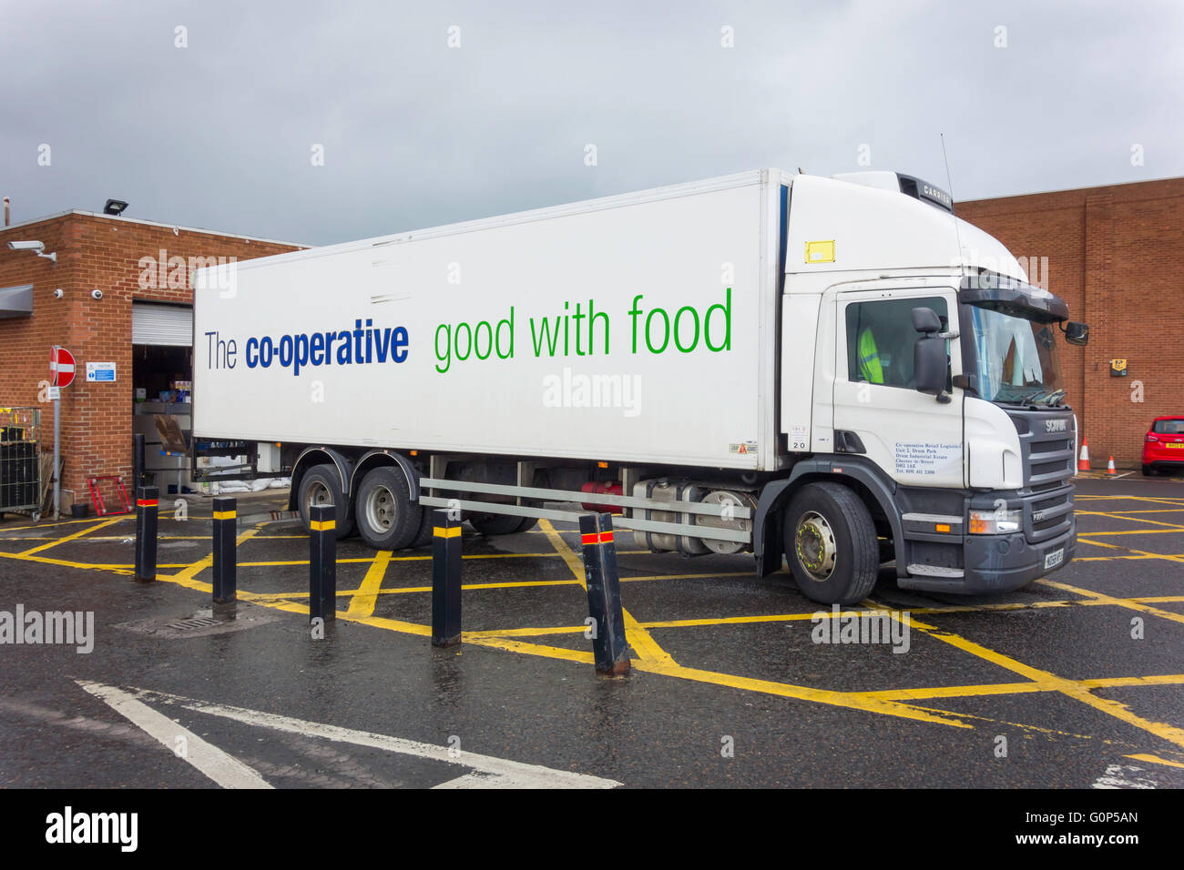 Large lorry delivering goods to a Co-operative Supermarket Stock Photo