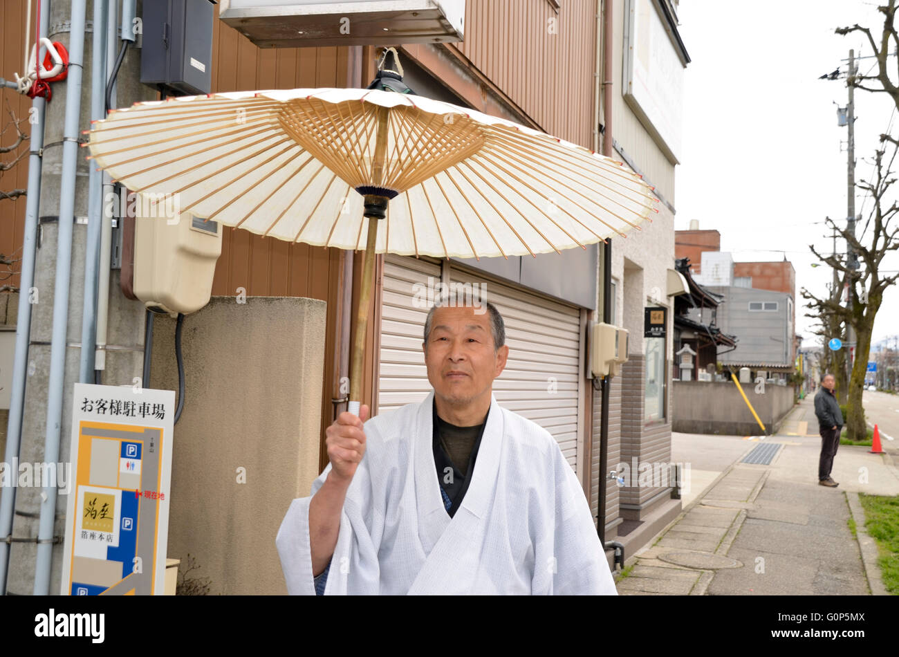 Man in traditional dress parasol hi-res stock photography and images ...