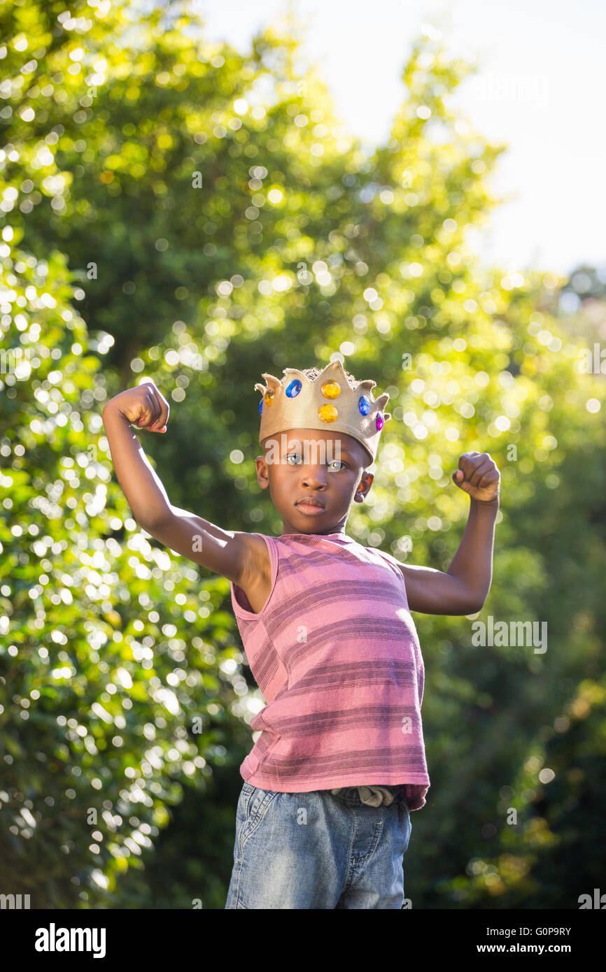 Boy putting arms up with crown Stock Photo