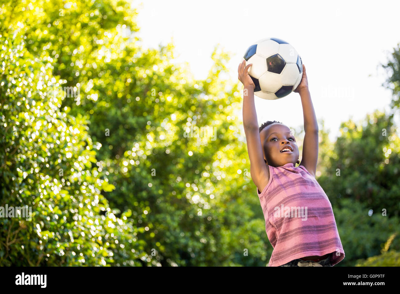 Boy is catching a soccer ball Stock Photo