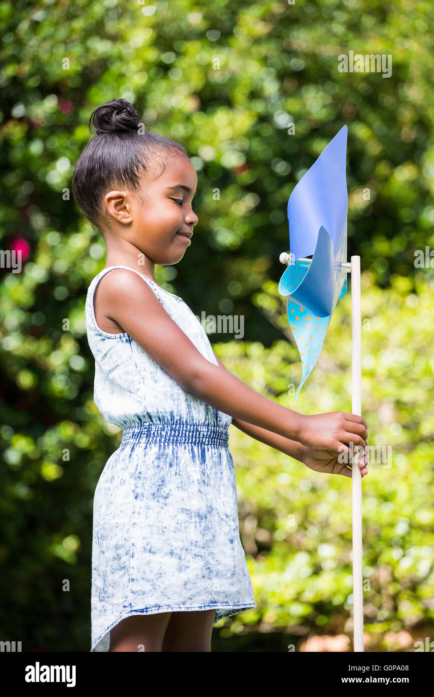 Little girl holding a pinwheel at park Stock Photo