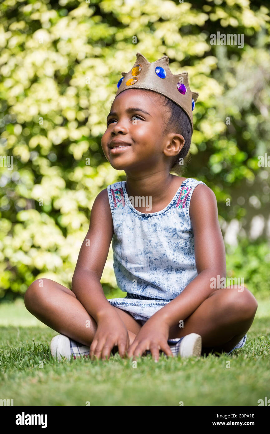Smiling little girl with legs crossed Stock Photo