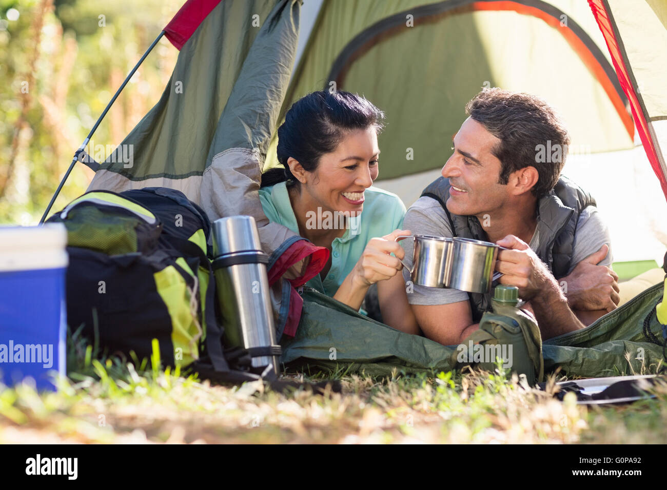 Couple laying and clinking cup Stock Photo