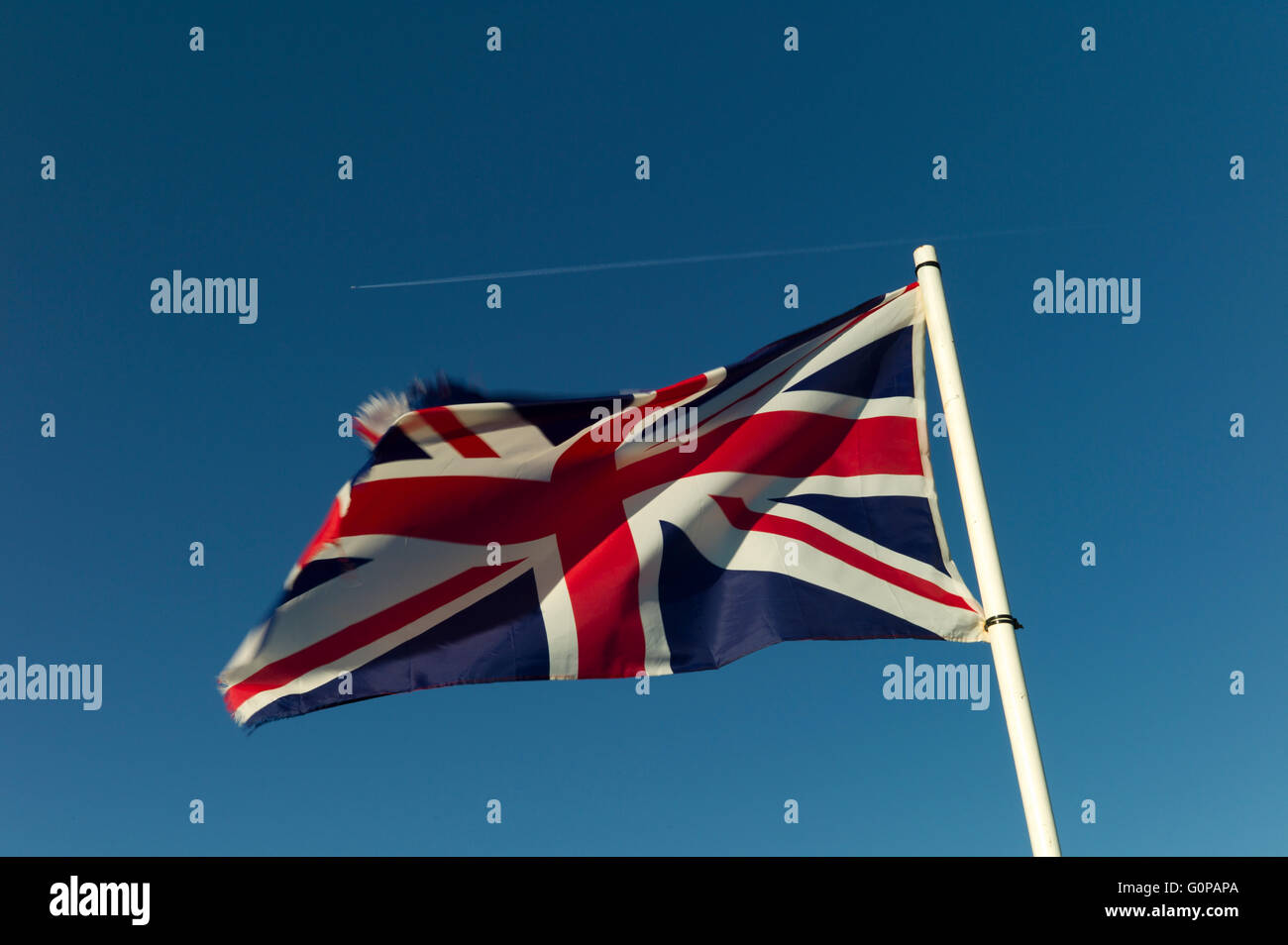 Union Jack flag against blue sky Stock Photo - Alamy