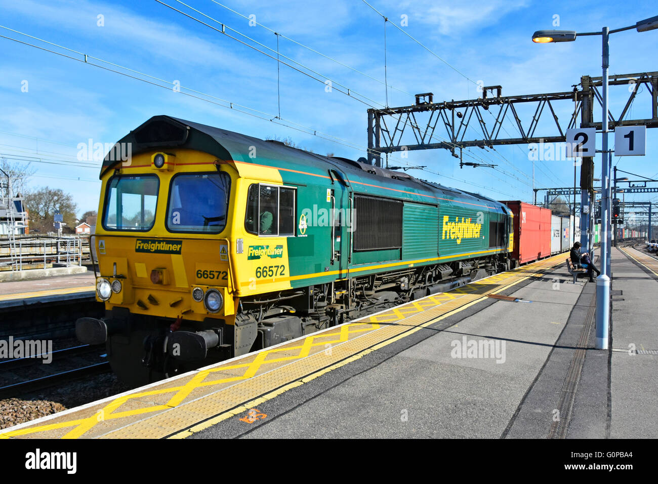 Freightliner locomotive 66572 on a shipping container train passing through Shenfield train station heading towards London England UK Stock Photo