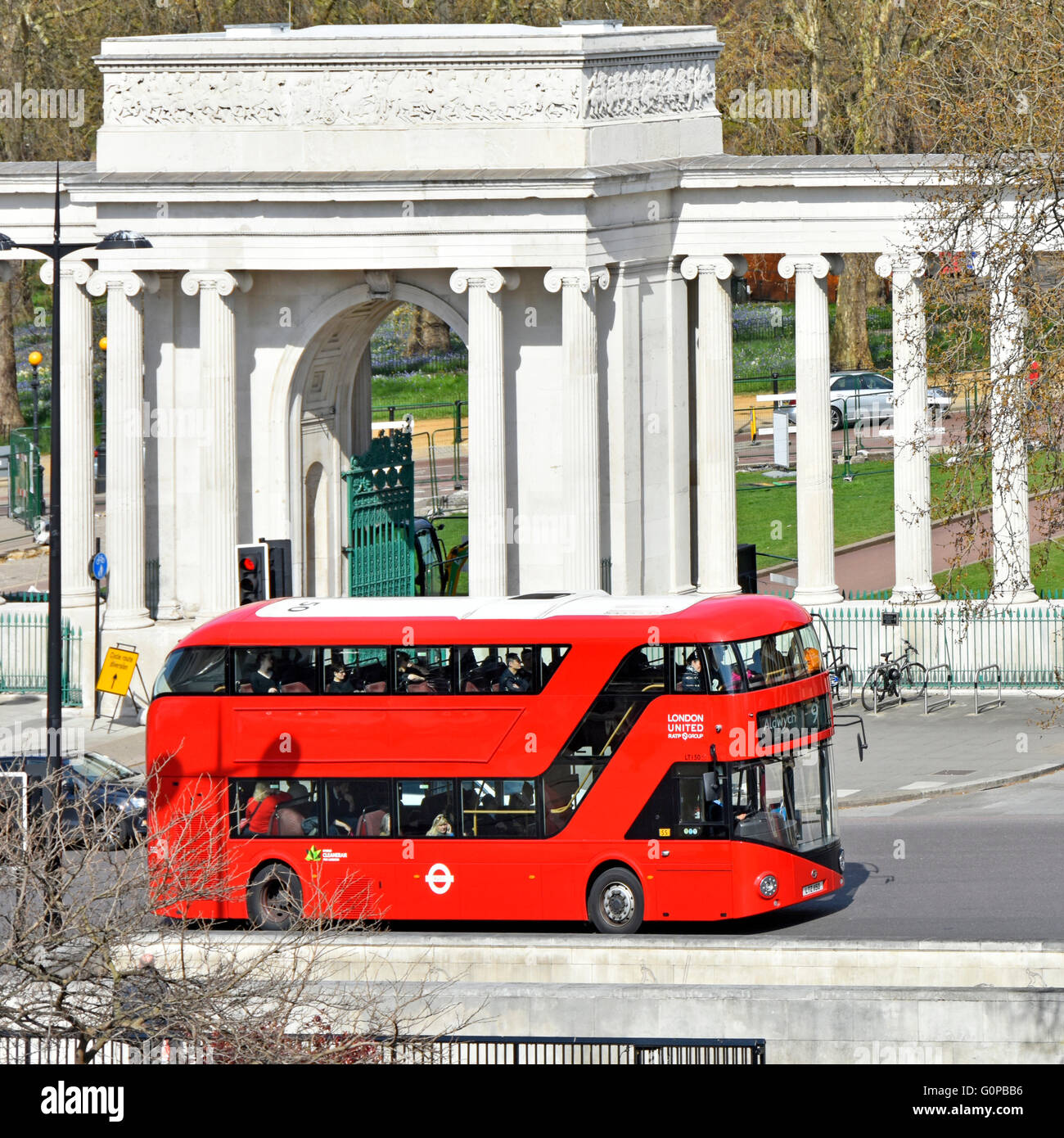 New London routemaster red bus without adverts on route nine passing Hyde Park corner screen at Hyde Park Corner road junction London England UK Stock Photo