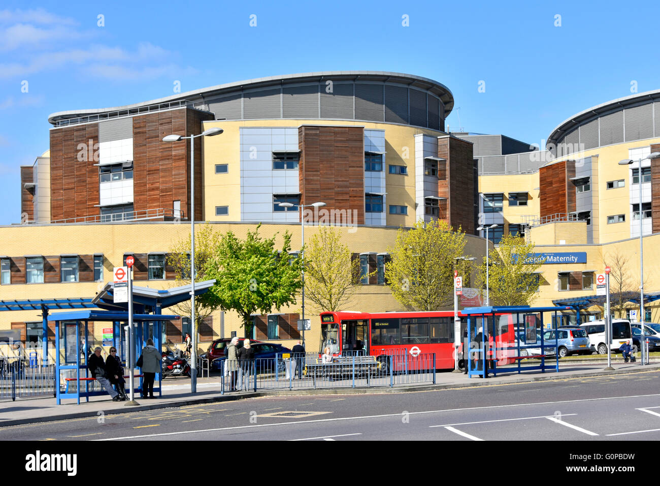 Bus stops at Queens General Hospital Romford includes sign for the Maternity Unit entrance to ward in the East London Borough of Havering England UK Stock Photo