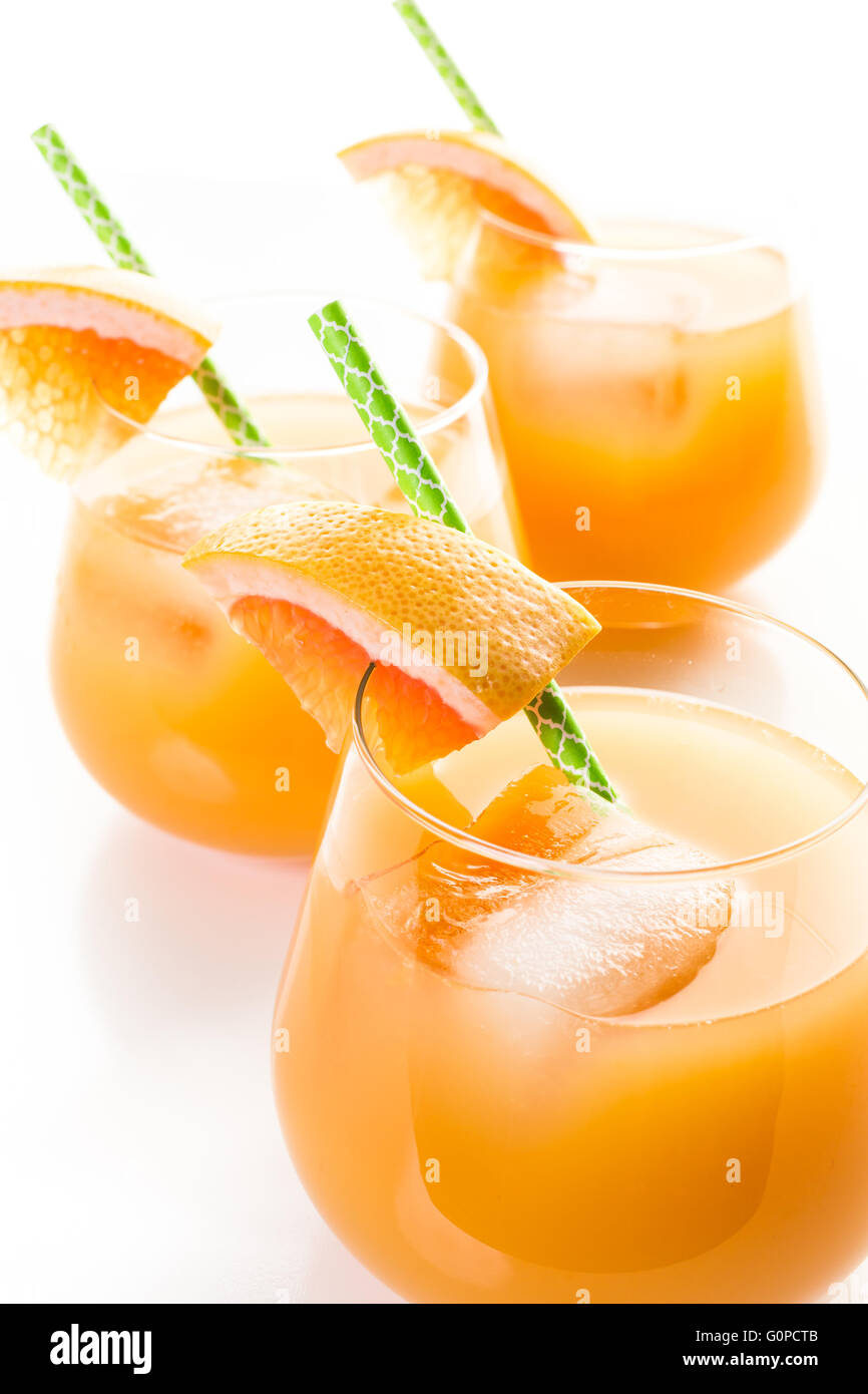 Organic ryby red grapefruit juice in small glass with ice. Stock Photo