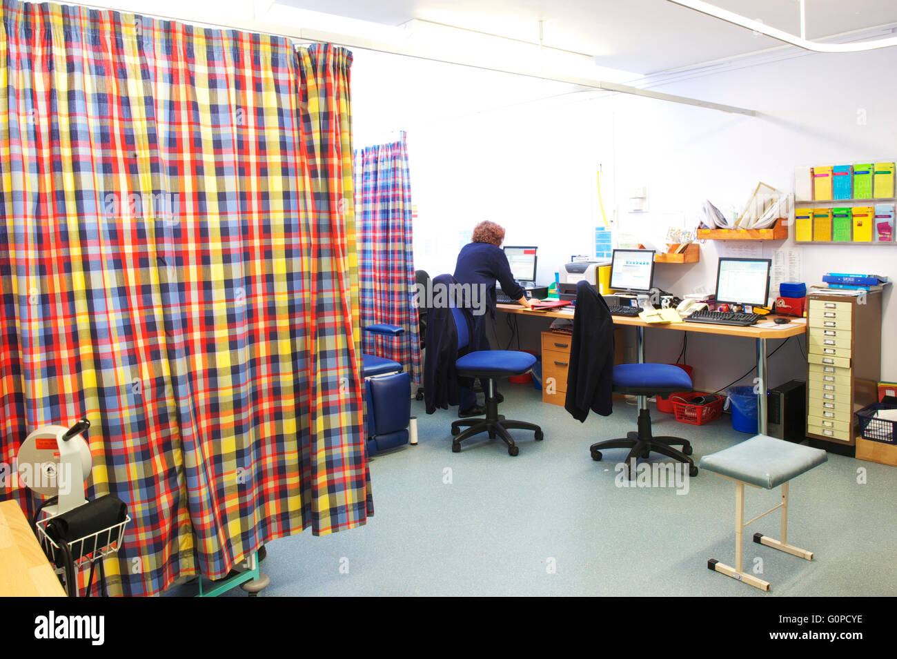 Nurses station in a UK general practice / GP Surgery with patients behind the curtain Stock Photo