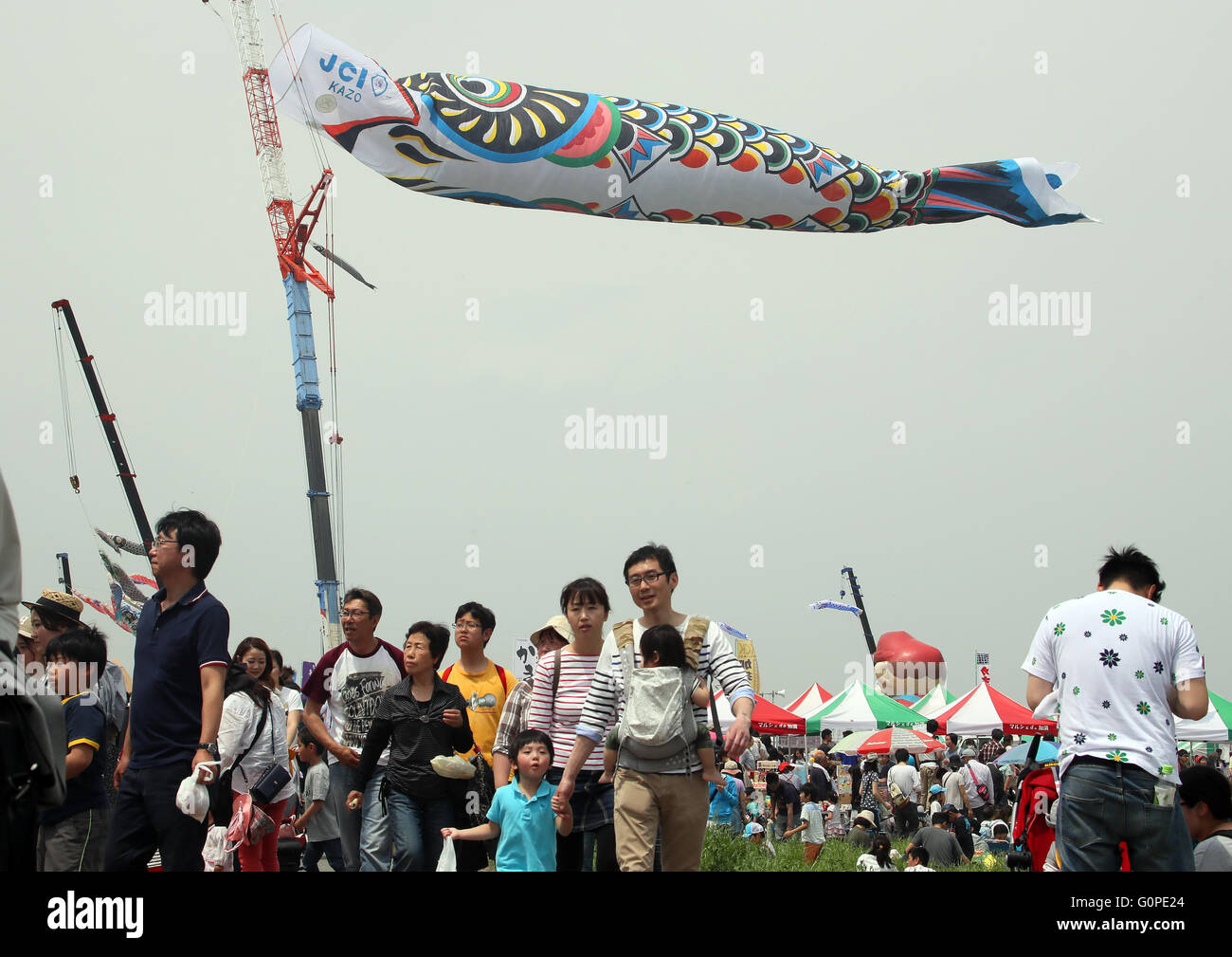 Saitama, Japan. 3rd May, 2016. A large carp streamer flies above the Tone River in Kazo city in Saitama prefecture, north of Tokyo on Tuesday, May 3, 2016 as a part of the city's annual peace festival. The carp streamer, 100 meters in length and weighing 330 kilograms, is being displayed to celebrate Japan's Children's Day on May 5 where parents wih their boys to grow up as strong as the carp. Credit:  Yoshio Tsunoda/AFLO/Alamy Live News Stock Photo