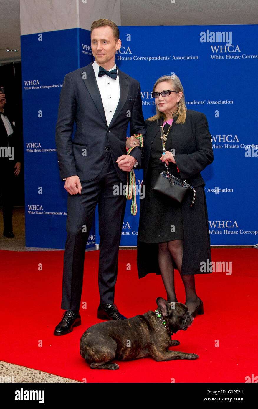Actors Tom Hiddleston, left, and Carrie Fisher with her dog Gary arrive for the 2016 White House Correspondents Association Annual Dinner at the Washington Hilton Hotel on Saturday, April 30, 2016. Credit: Ron Sachs / CNP (RESTRICTION: NO New York or New Jersey Newspapers or newspapers within a 75 mile radius of New York City) - NO WIRE SERVICE - Stock Photo