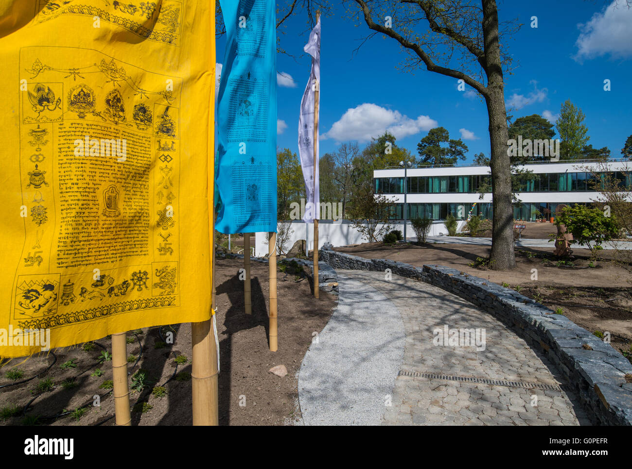 Tibetan prayer flags flying in front of the newly erected Sukhavati Spiritual Care Center in Bad Saarow, Germany, 02 May 2016. The Buddhist residential and nursing project is scheduled to be opened on 04 May 2016. The name of the centre includes the term 'Sukhavati' that translates to 'Land of Bliss.' Photo: PATRICK PLEUL/dpa Stock Photo