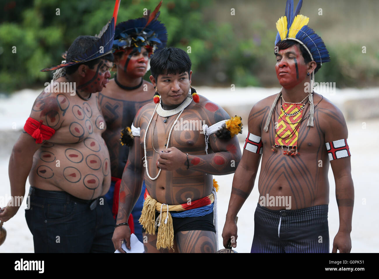Brazilian indigenous torch carriers prepare for their turn as the Olympic flame relay kicks off May 3, 2016 in Brasilia, Brazil. The torch relay will begin a three month journey around Brazil before arriving for the Rio de Janeiro Olympics in August. Stock Photo