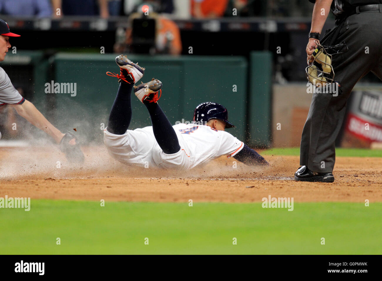 Houston, TX, USA. 03rd May, 2016. Houston Astros right fielder George Springer (4) slides across home plate to score a run on a wild pitch during the third inning of the MLB baseball game between the Houston Astros and the Minnesota Twins from Minute Maid Park in Houston, TX. Credit image: Erik Williams/Cal Sport Media/Alamy Live News Stock Photo