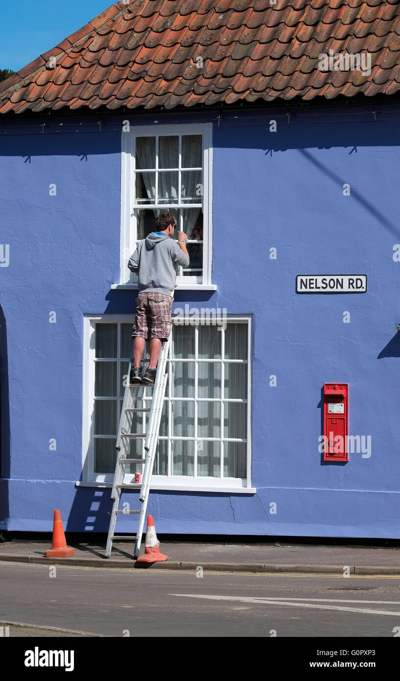 painter and decorator painting exterior of house Stock Photo