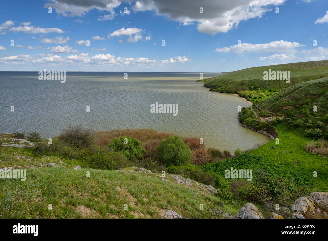Lake shore view with cloudy sky Stock Photo - Alamy
