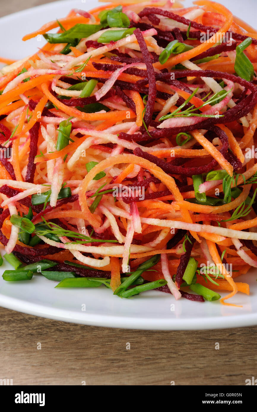 plate salad of shredded raw beets, and carrots  on celery root  close-up Stock Photo