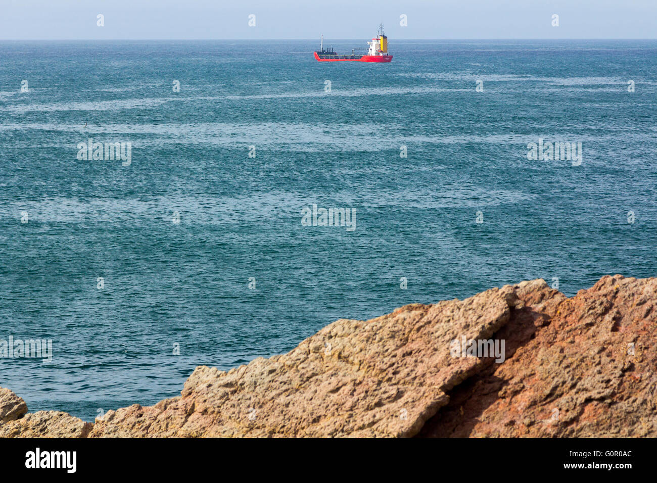 Merchant ship sailing by sea Stock Photo