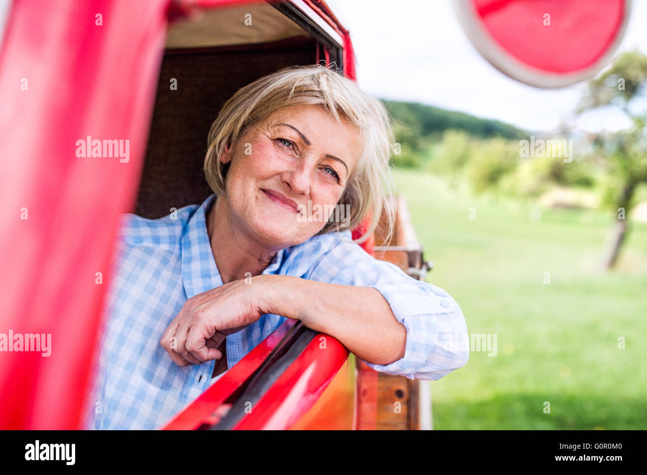 Close up of senior woman inside vintage pickup truck Stock Photo - Alamy