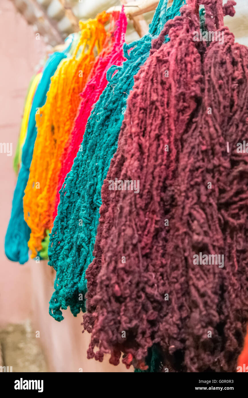 Colorful yarns traditionally made of Llama and Alpaca in Andes Mountains near Cusco, Peru Stock Photo