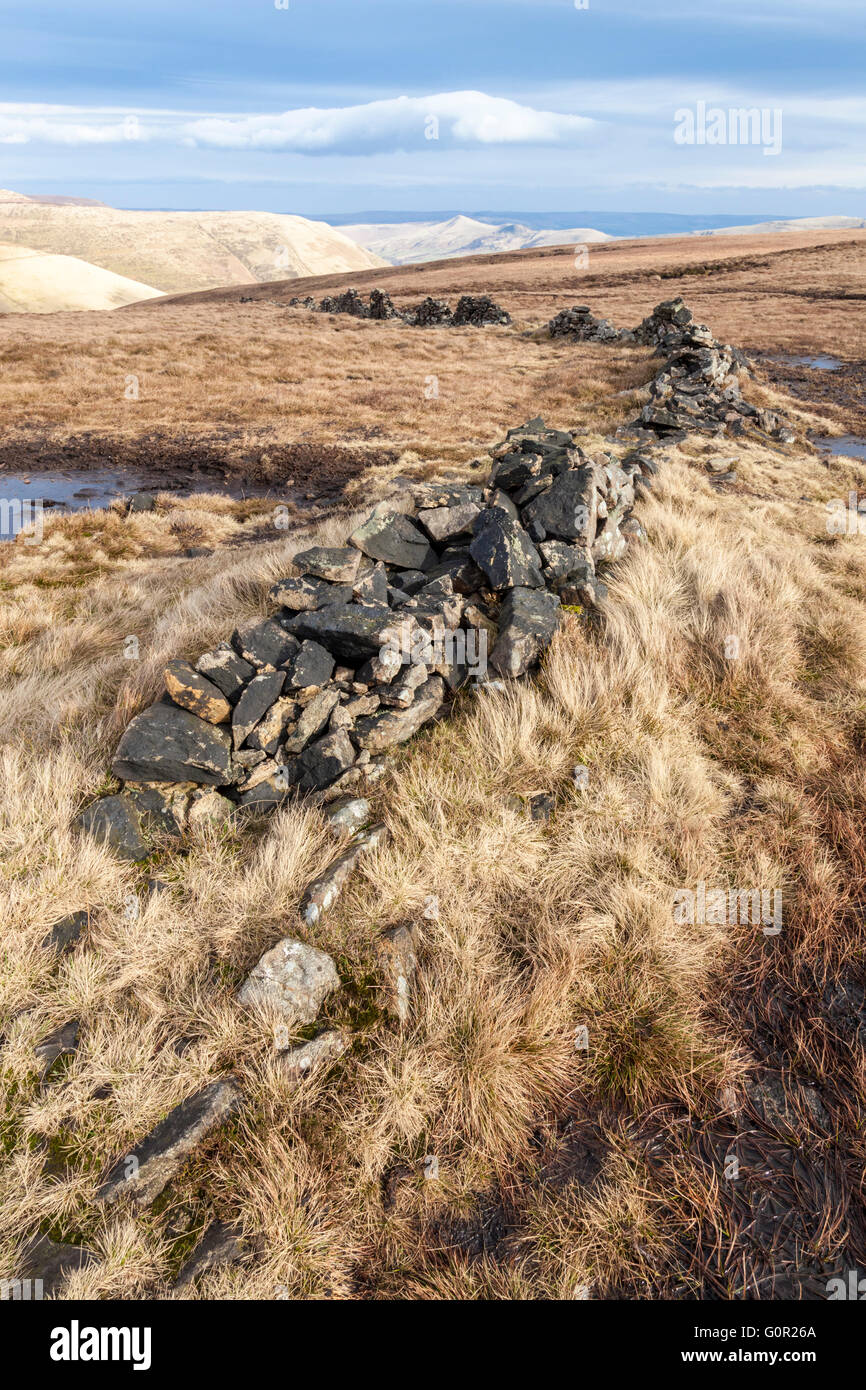 Collapsed old stone wall on peat bog moorland in winter. Colborne Moor, Derbyshire, Peak District National Park, England, UK Stock Photo