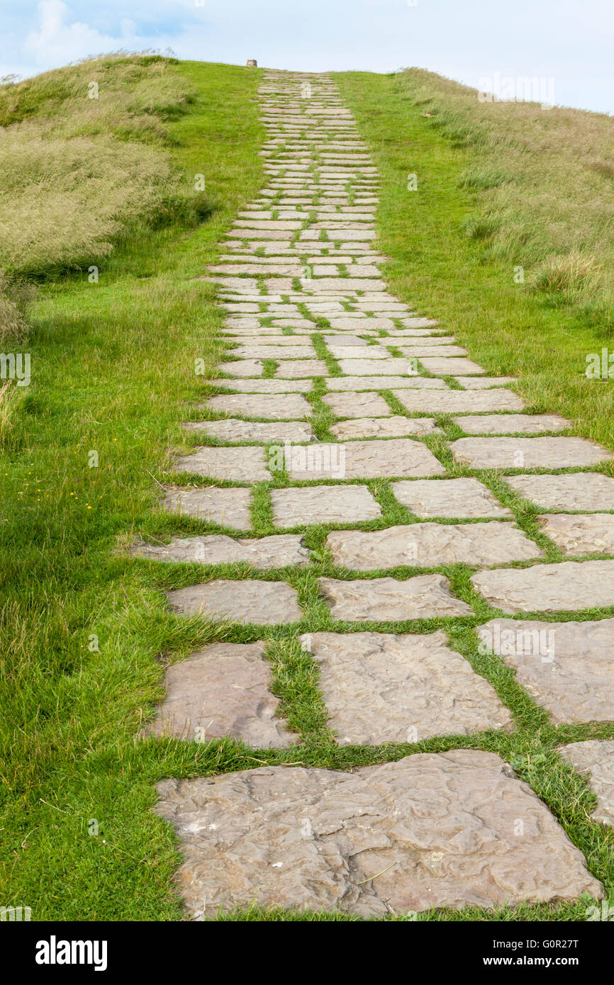 Paved stone path or footpath on a hill in the countryside. Near the top of Mam Tor, Derbyshire, Peak District National Park, England, UK Stock Photo