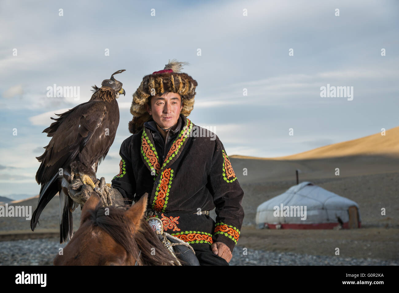 Man In Traditional Clothing On A Horse Holding A Golden