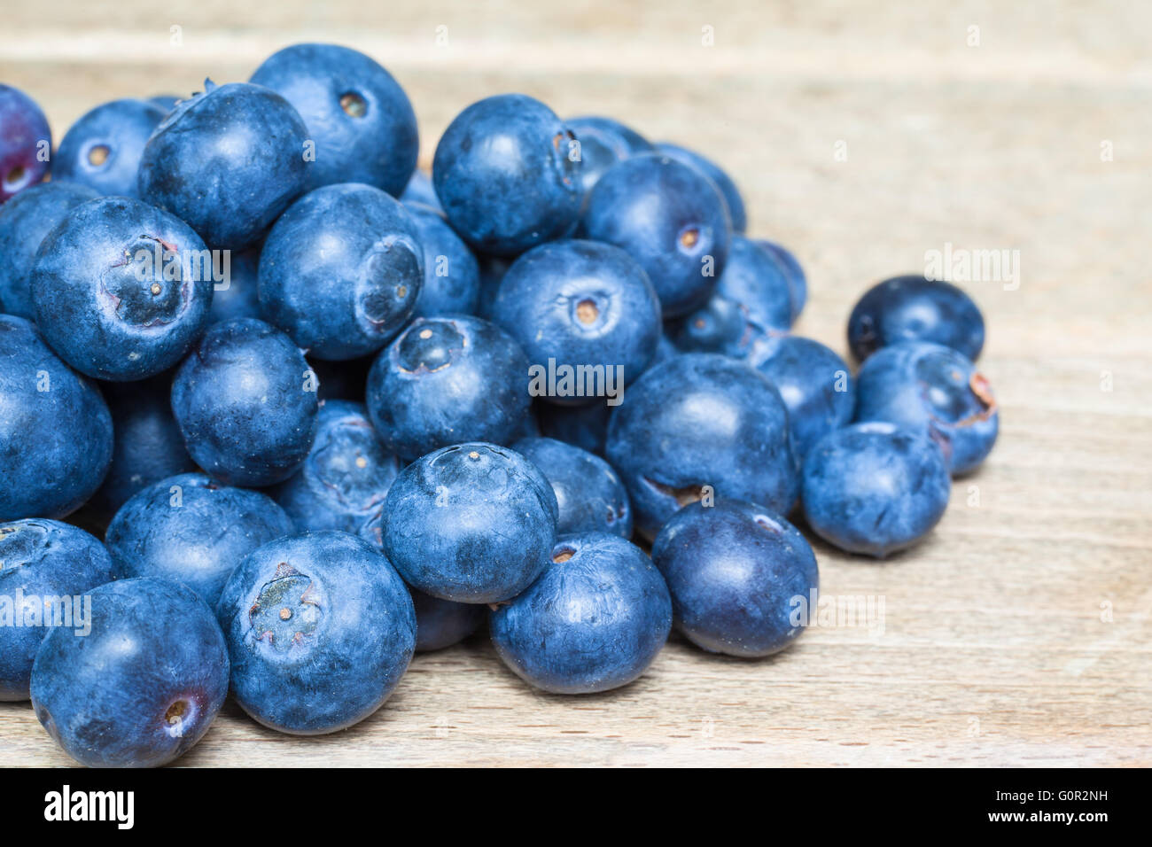 Close up view of a small heap of blackberry with wood background Stock Photo