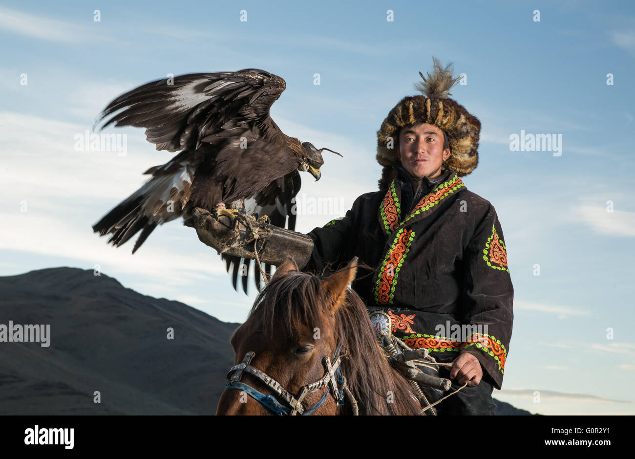Man In Traditional Clothing On A Horse Holding A Golden