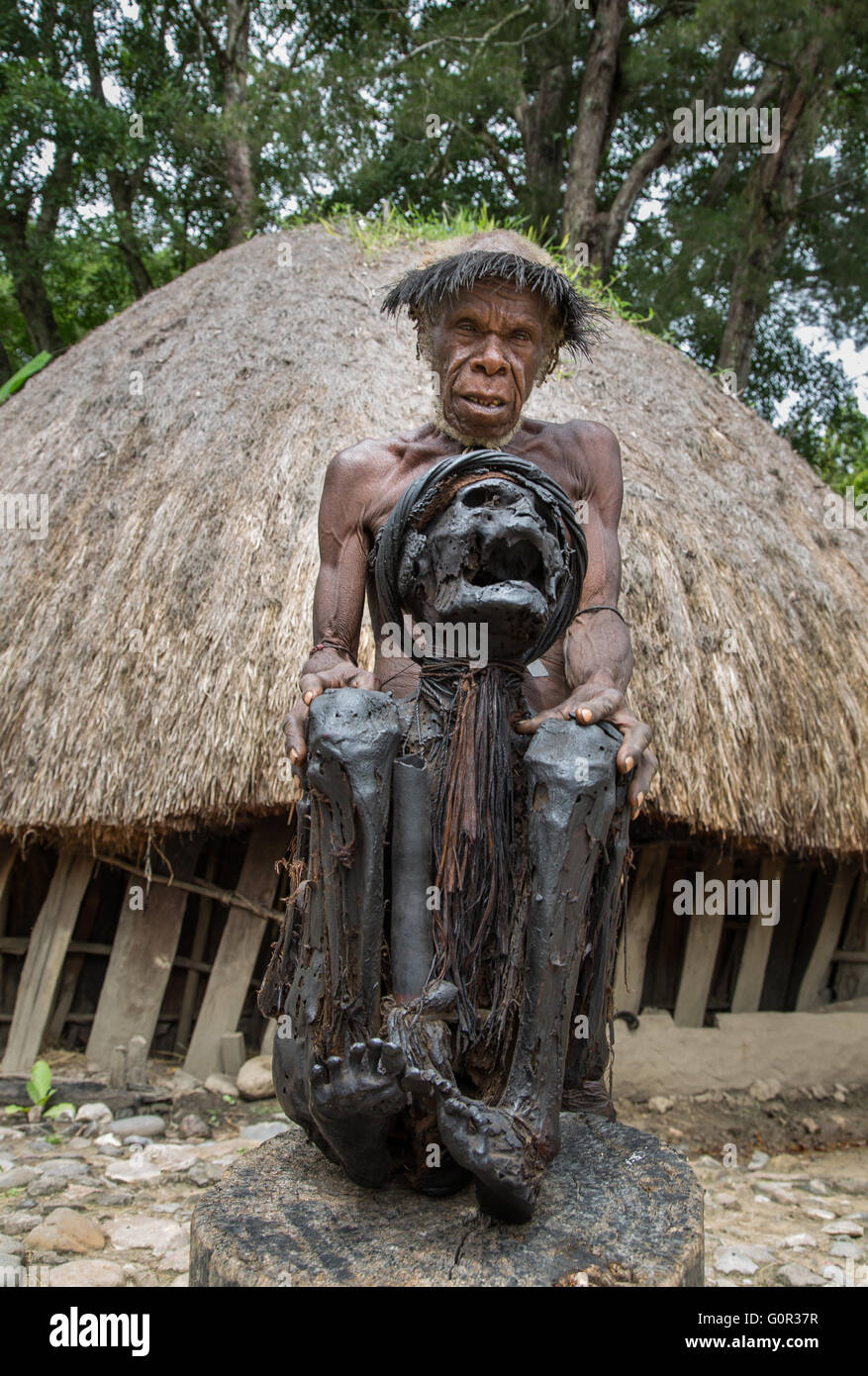 DAni tribe man is showing off a mummy of a village elder Stock Photo