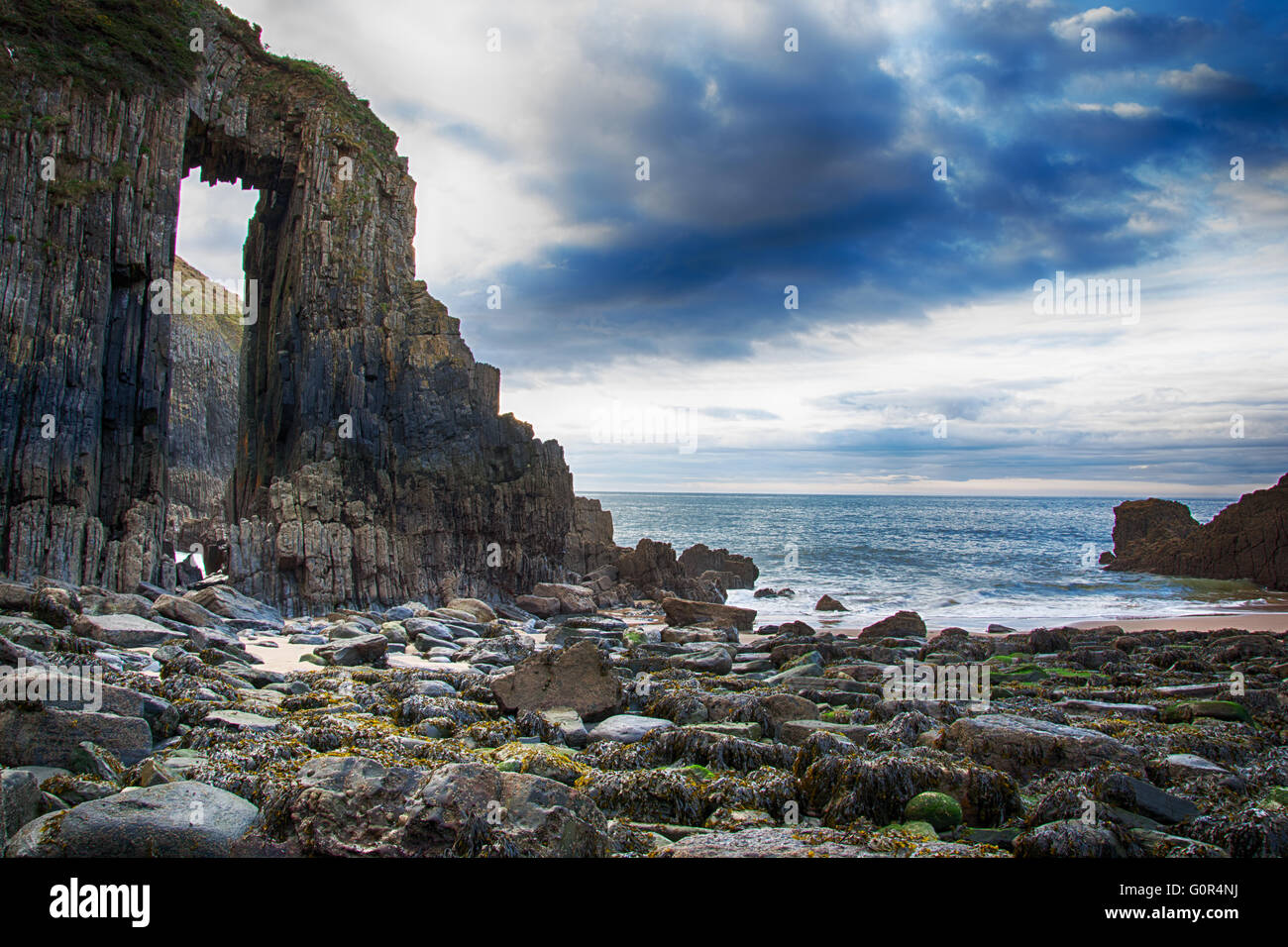 Church Doors rock formation in Skrinkle Haven cove with surf washing ...